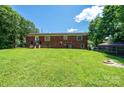 Large backyard features a well-maintained lawn and fenced perimeter at 559 15Th Se Ave, Hickory, NC 28602
