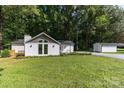 The exterior of this home features a gable roof and dormer, large front yard, deck, and a detached garage at 7032 Waxhaw Hwy, Lancaster, SC 29720