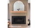 Modern fireplace featuring decorative mirror above the mantle and elegant sconce lighting at 728 Falling Oak Aly # 21, Huntersville, NC 28078