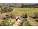 Wide aerial shot of the home's setting, surrounded by greenery and distant fields at 925 Marys Grove Rd, Cherryville, NC 28021