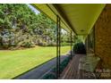 View from the front porch looking out to the lush green lawn and mature trees at 938 Kannapolis Pkwy, Concord, NC 28027