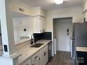 Well-lit kitchen featuring stainless steel appliances, stylish countertops, and a black backsplash at 11123 Harrowfield Rd, Charlotte, NC 28226