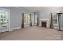 Bright living room with neutral carpet, fireplace, and plenty of natural light at 1173 Cat Square Rd, Vale, NC 28168