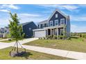 Beautiful two-story home featuring manicured landscaping and a bright red front door at 1516 Respect Nw St, Concord, NC 28027