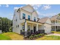 Elegant two-story home with stone accents, a welcoming front porch, and well-maintained landscaping at 154 Cotton Field Dr, Statesville, NC 28677