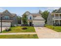 Beautifully landscaped front yard with a charming two-story home featuring a two-car garage and classic design at 154 Cotton Field Dr, Statesville, NC 28677