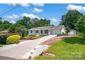 Inviting home showcasing a long driveway, manicured lawn, and charming exterior features at 172 Wildwood Loop, Statesville, NC 28625