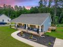 Inviting home with a cozy front porch, a lush yard, and meticulously landscaped flower beds at 1916 Bess Town Rd, Bessemer City, NC 28016