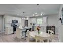 Bright kitchen with white cabinets, stainless steel appliances, kitchen island, and modern lighting at 1916 Bess Town Rd, Bessemer City, NC 28016