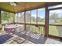 Inviting screened porch with seating, offering serene outdoor living space at 3206 Basilwood Cir, Monroe, NC 28110