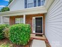 Inviting front entrance with brick accents, lush greenery, and a clear view of the house number at 3830 Brookchase Ln, Charlotte, NC 28205