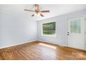 Bright living room featuring hardwood floors, a ceiling fan, and a large window at 408 Kennerly Dr, Indian Trail, NC 28079