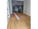 Open-concept living space with hardwood floors, recessed lighting, and a view into the kitchen at 409 Everette St, Monroe, NC 28112