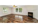 Inviting living room with a cozy fireplace, expansive windows, and stylish laminate flooring, creating a warm atmosphere at 508 Bridgestone Ln, Rock Hill, SC 29730