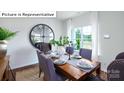 A well-lit dining room featuring a wooden table and a large decorative mirror at 513 Jacobus Ln, Monroe, NC 28112