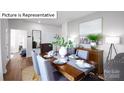 A stylish dining room with a wooden table, chairs, and decorative accents at 513 Jacobus Ln, Monroe, NC 28112