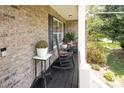 Cozy front porch featuring rocking chairs, plants, and classic brickwork at 551 Sand Trap Dr, York, SC 29745