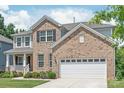 Beautiful two-story brick home with attached two-car garage and well-maintained landscaping at 6320 Tilley Way, Matthews, NC 28105