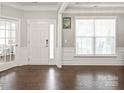 Elegant foyer with hardwood floors, neutral paint, and natural light from large window at 6320 Tilley Way, Matthews, NC 28105