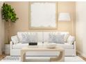 Cozy living room with a white sofa, modern decor, and ample natural light at 6349 Fairfax Ct, Maiden, NC 28650
