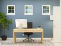 Bright office space with a sleek desk, modern computer, and calming blue walls, ideal for productivity at 6382 Fairfax Ct, Maiden, NC 28650