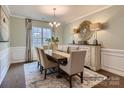 Elegant dining room featuring a wooden table with seating for six, complemented by a stylish chandelier and buffet at 6388 Fairfax Ct, Maiden, NC 28650