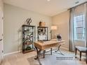 Cozy study with neutral walls, plush carpet, large window and stylish shelving units to display books and plants at 6388 Fairfax Ct, Maiden, NC 28650
