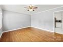 Bright living room featuring hardwood floors, neutral walls, and a ceiling fan, creating a comfortable and inviting atmosphere at 814 W Gold St, Kings Mountain, NC 28086