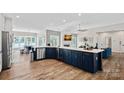 Modern kitchen with white countertops, navy cabinets, and stainless steel appliances at 849 Kemp Rd, Mooresville, NC 28117