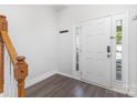 Inviting entryway showcasing a bright front door with side lights and hardwood floors at 9720 Walkers Glen Nw Dr, Concord, NC 28027