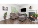 Cozy living room featuring a fireplace, comfortable seating, and abundant natural light at 9720 Walkers Glen Nw Dr, Concord, NC 28027