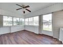Bright sunroom featuring wood floors, large windows, and a ceiling fan at 104 W Maryland Ave, Bessemer City, NC 28016