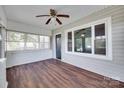 Sunroom boasts wood floors, great windows, and a ceiling fan at 104 W Maryland Ave, Bessemer City, NC 28016