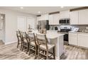 Modern kitchen with a large island, stainless steel appliances, and white cabinetry at 105 Watuga Pl, Statesville, NC 28625
