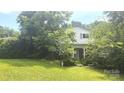 Charming two-story home with brick and white exterior, front porch, and covered in trees at 11056 Us Highway 52 N Hwy, Wadesboro, NC 28170