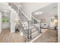 Bright foyer with hardwood floors and staircase with decorative spindles and wood accents at 1125 Victoria Blake Ln, Belmont, NC 28012
