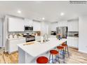 Modern kitchen with white cabinets, stainless steel appliances, and a spacious island with seating at 115 Oconee Trl, Statesville, NC 28625