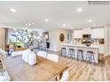 Open concept living space featuring a large dining table, kitchen island with bar stools, and cozy living area at 115 Oconee Trl, Statesville, NC 28625