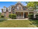 Attractive brick home with a well-maintained lawn and inviting covered front porch at 125 Snow Fountain Ln, Mooresville, NC 28115