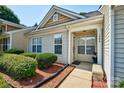 Inviting townhouse entrance with a cozy front porch, well-kept shrubbery, and visible house number at 1504 Harpers Inlet Dr, Lake Wylie, SC 29710
