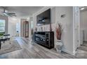 Open-concept living room with fireplace, large screen television, and stylish decorations at 1504 Harpers Inlet Dr, Lake Wylie, SC 29710