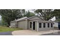 Exterior view of garage with gray siding and four windows at 1521 N Piedmont Ave, Kings Mountain, NC 28086
