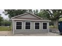 Garage exterior with four windows and gray siding at 1521 N Piedmont Ave, Kings Mountain, NC 28086