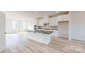 Modern kitchen featuring white cabinets, stainless steel appliances, and a granite-topped island at 2143 Barrowcliffe Nw Dr, Concord, NC 28027