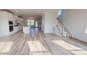 Bright, open-concept living room with hardwood floors, staircase, and an abundance of natural light at 2143 Barrowcliffe Nw Dr, Concord, NC 28027