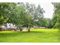 Spacious backyard featuring a covered patio area perfect for outdoor entertaining and relaxation at 218 Blacksnake Rd, Stanley, NC 28164