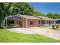 Brick home with carport and covered porch, offering convenient parking and outdoor space at 2526 Ashford Dr, Newton, NC 28658