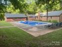 Backyard pool features a concrete deck and mature trees at 4050 Rollingwood Cir, Rock Hill, SC 29732