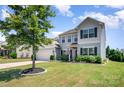 Inviting two-story home features a lush front yard, well maintained lawn, and classic architectural details at 5079 Nighthawk Dr, Fort Mill, SC 29707