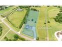 Aerial shot of a sprawling property, showcasing the house, manicured lawn, and tree-lined boundaries at 594 Patterson Farm Rd, Mooresville, NC 28115